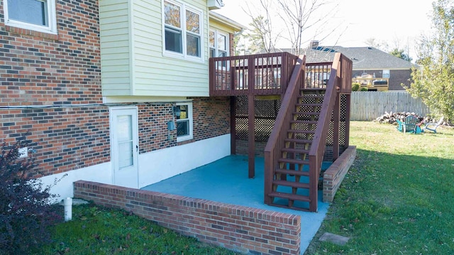 exterior space with a wooden deck and a lawn