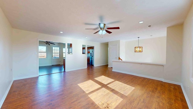 spare room featuring hardwood / wood-style flooring and ceiling fan