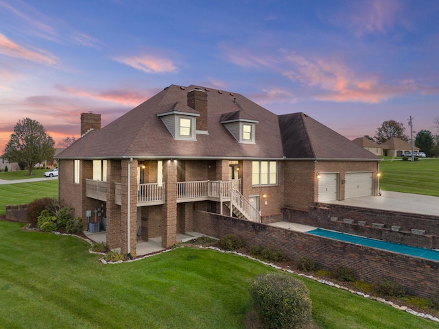 exterior space with a garage and a lawn