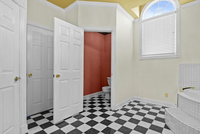 bathroom with crown molding, toilet, and tiled tub