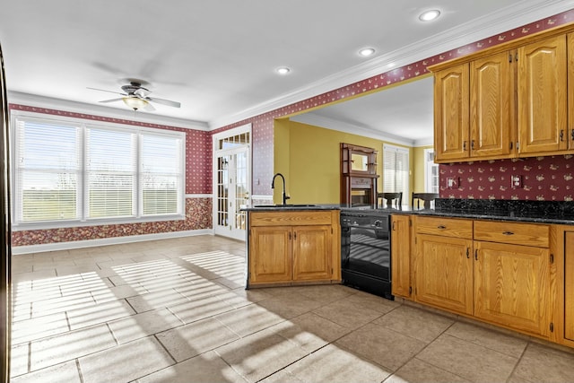 kitchen featuring dishwasher, sink, dark stone countertops, ornamental molding, and kitchen peninsula