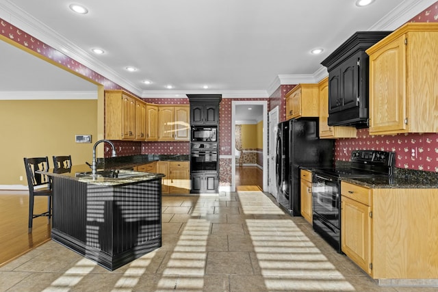 kitchen featuring sink, a kitchen breakfast bar, dark stone counters, ornamental molding, and black appliances