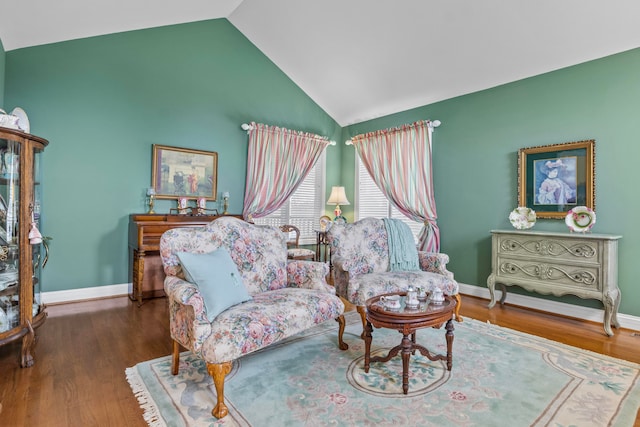 sitting room featuring hardwood / wood-style flooring and vaulted ceiling