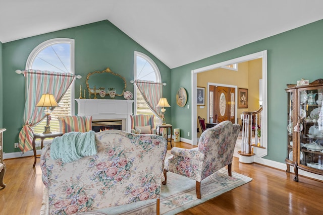 living room with vaulted ceiling and light hardwood / wood-style floors