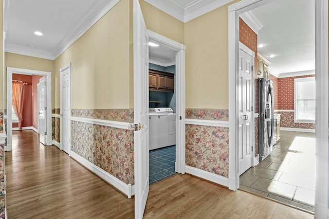 hallway with crown molding, wood finished floors, and wallpapered walls
