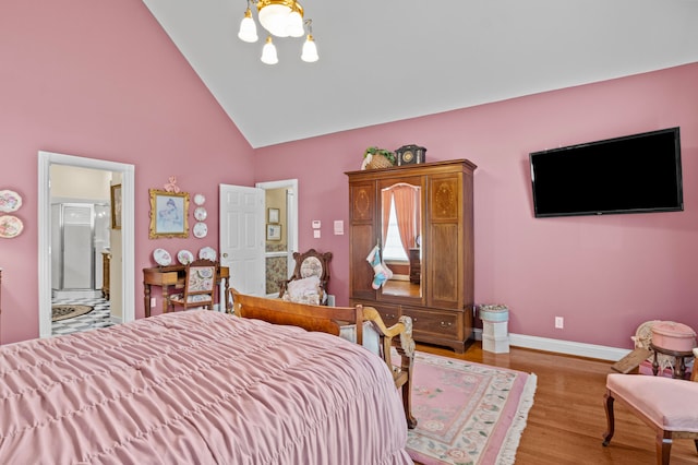 bedroom featuring ensuite bathroom, high vaulted ceiling, and light hardwood / wood-style flooring