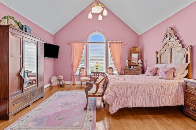 bedroom featuring lofted ceiling and hardwood / wood-style floors