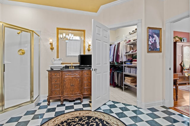 bathroom featuring an enclosed shower, vanity, crown molding, and a chandelier