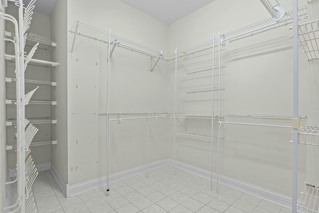spacious closet with tile patterned floors