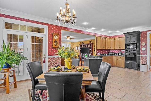 dining area with sink, ceiling fan with notable chandelier, and ornamental molding