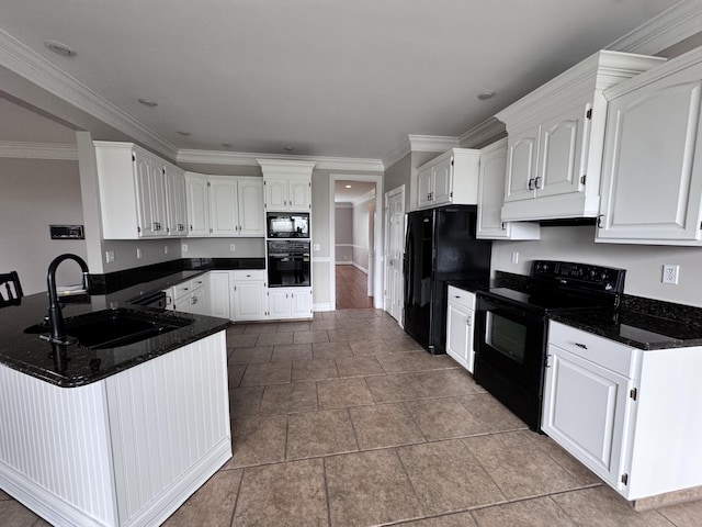 kitchen with a peninsula, white cabinetry, a sink, and black appliances