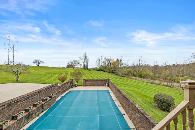 view of swimming pool featuring a yard and a patio