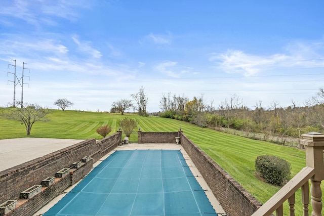 view of swimming pool with a lawn