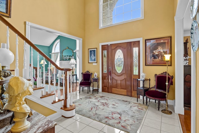 tiled entrance foyer with a high ceiling