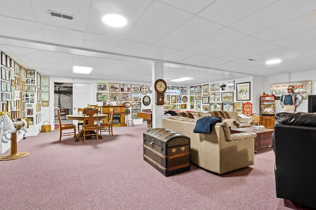 carpeted living room with a paneled ceiling