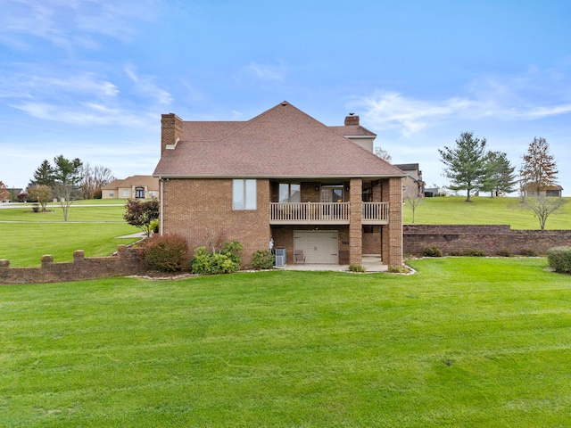 rear view of house with a patio, a balcony, central air condition unit, and a lawn