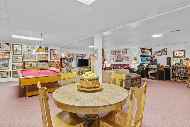 carpeted dining room featuring a drop ceiling