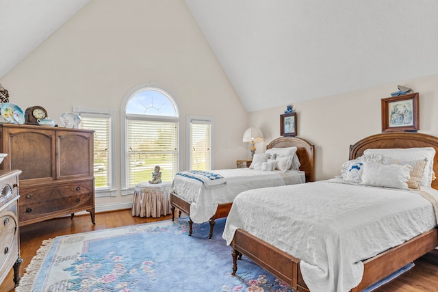 bedroom with vaulted ceiling and hardwood / wood-style floors