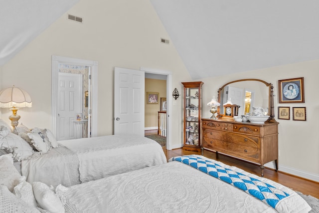 bedroom featuring hardwood / wood-style flooring and vaulted ceiling