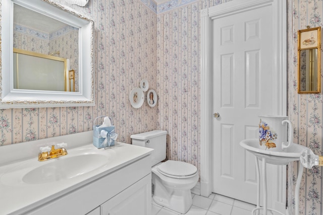 bathroom featuring vanity, toilet, and tile patterned flooring