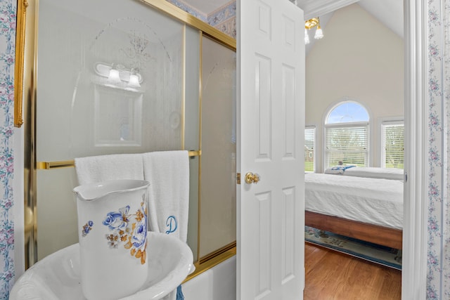 bathroom featuring lofted ceiling and wood-type flooring