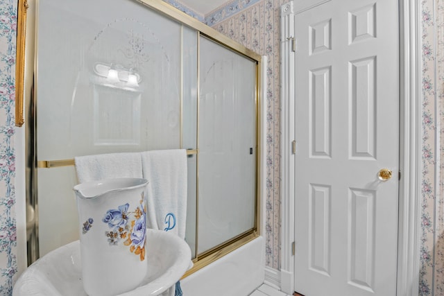 bathroom featuring bath / shower combo with glass door