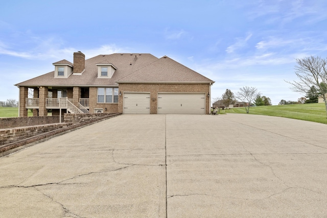 view of front facade featuring brick siding, an attached garage, driveway, and roof with shingles
