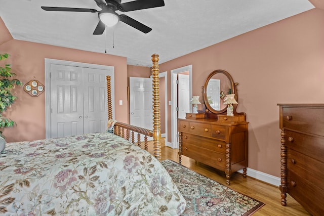 bedroom with ceiling fan, light hardwood / wood-style floors, and a closet