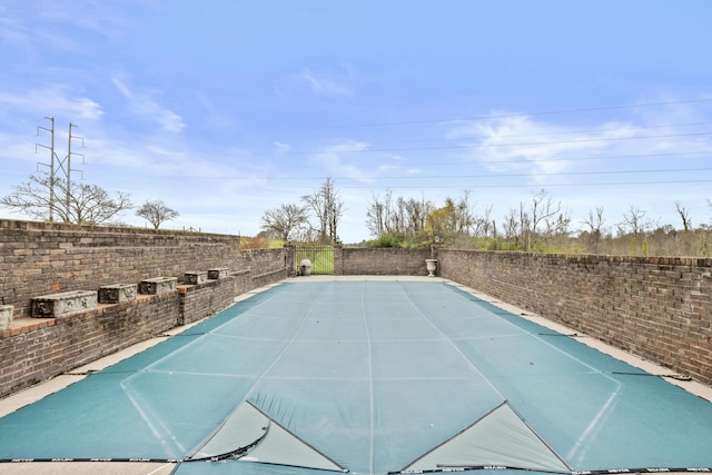 view of swimming pool featuring a fenced backyard