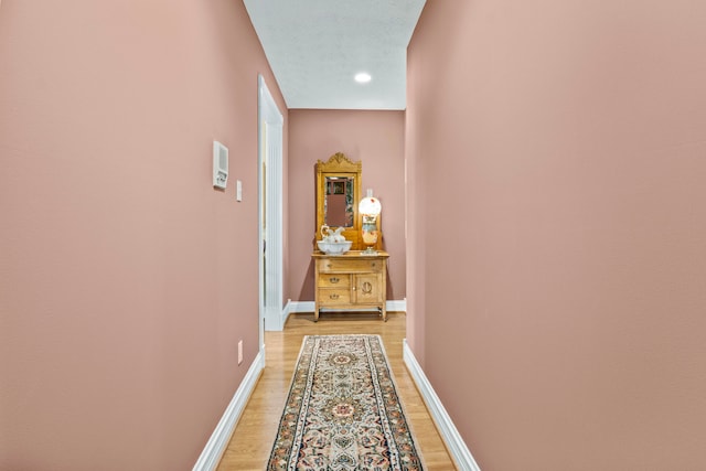 hall with wood-type flooring