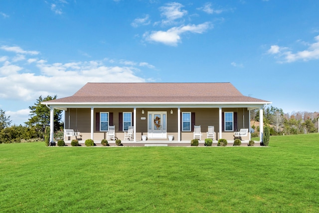 rear view of house with a lawn and covered porch