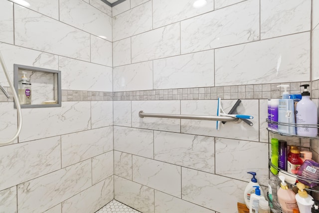 bathroom with a tile shower