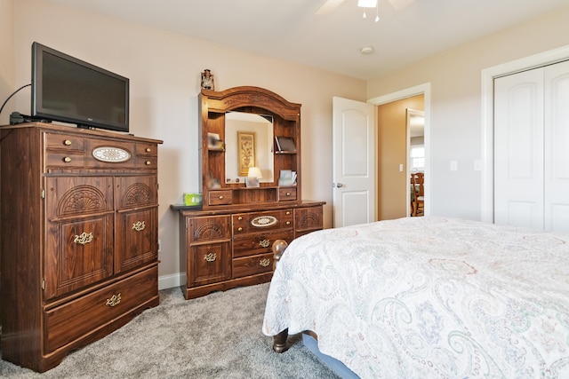 carpeted bedroom featuring ceiling fan and a closet