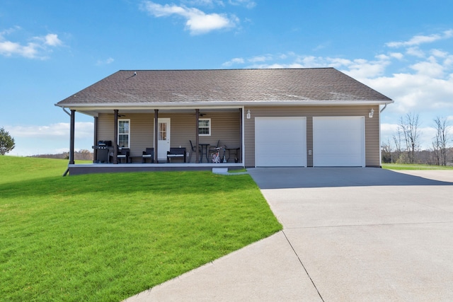 view of front of house featuring a front lawn, a garage, and covered porch