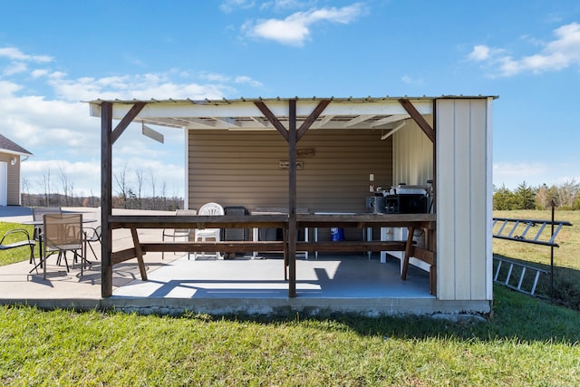 exterior space with a patio area and a lawn