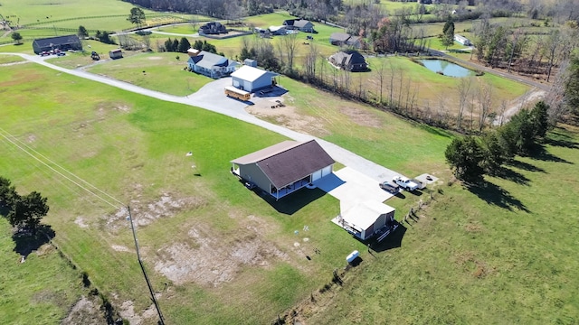 birds eye view of property featuring a water view and a rural view