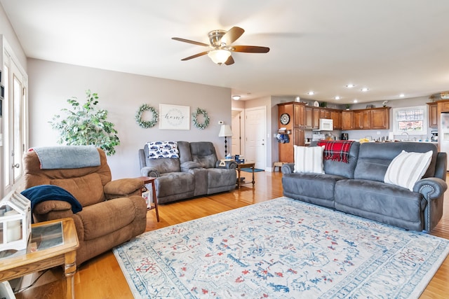 living room with light hardwood / wood-style floors and ceiling fan