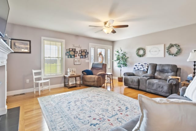 living room featuring hardwood / wood-style floors and ceiling fan