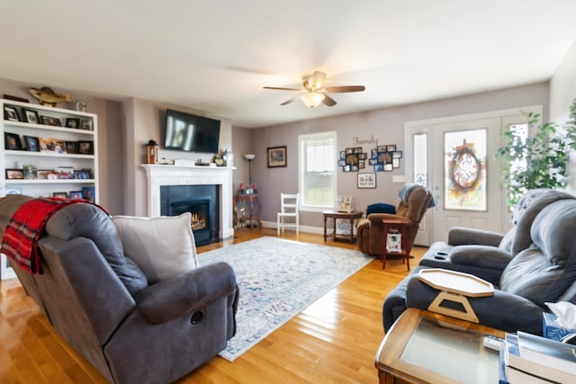 living room featuring hardwood / wood-style floors and ceiling fan