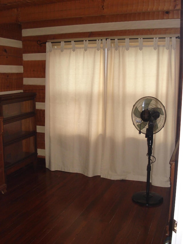 interior space featuring wood walls and hardwood / wood-style flooring