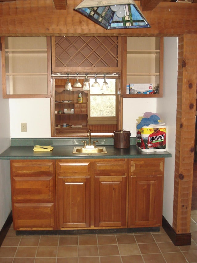 kitchen with dark tile patterned flooring and sink