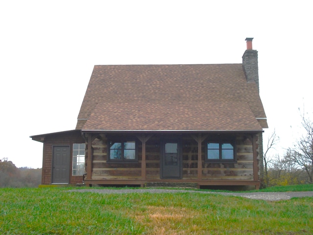 back of property featuring a yard