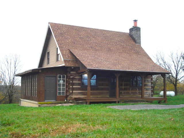 rear view of house with a lawn