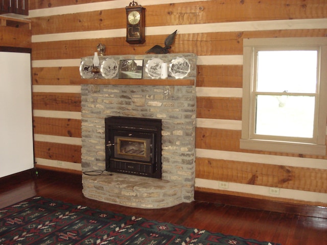 interior details featuring hardwood / wood-style floors and a wood stove