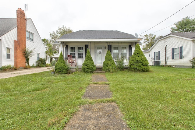 bungalow featuring central air condition unit, a front yard, and a porch