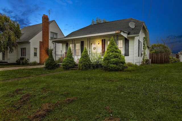 bungalow-style house with covered porch and a front yard