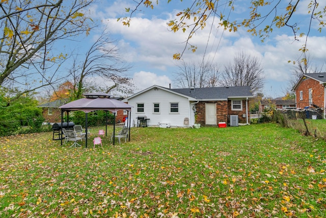 back of house featuring a gazebo, central AC, and a yard