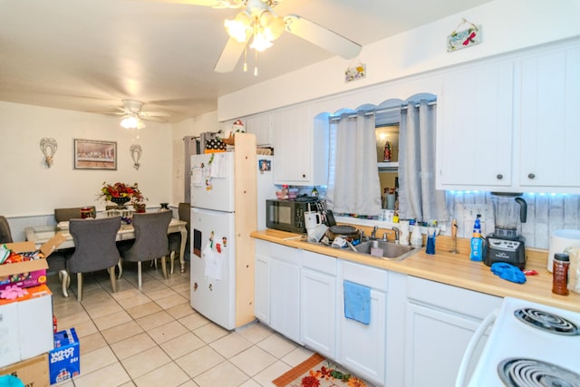 kitchen with white cabinetry, ceiling fan, white appliances, decorative backsplash, and light tile patterned floors