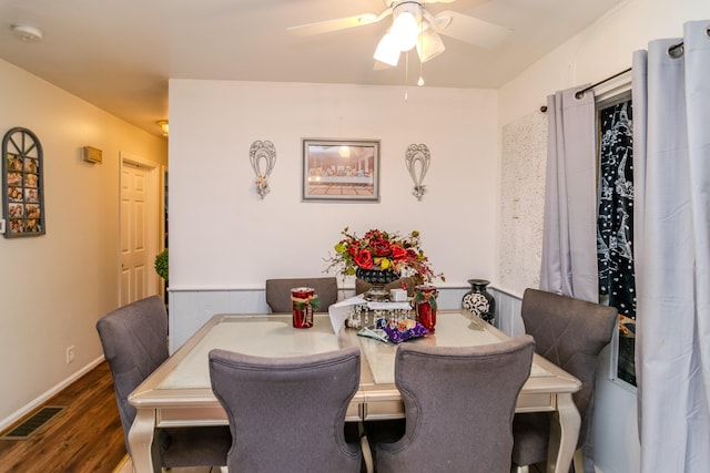 dining space featuring ceiling fan and dark hardwood / wood-style flooring