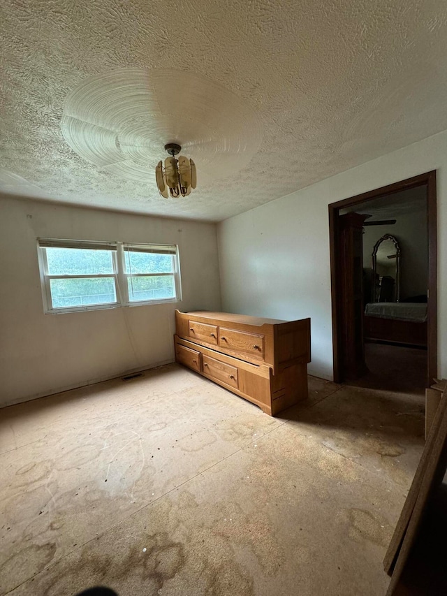 unfurnished bedroom with a textured ceiling